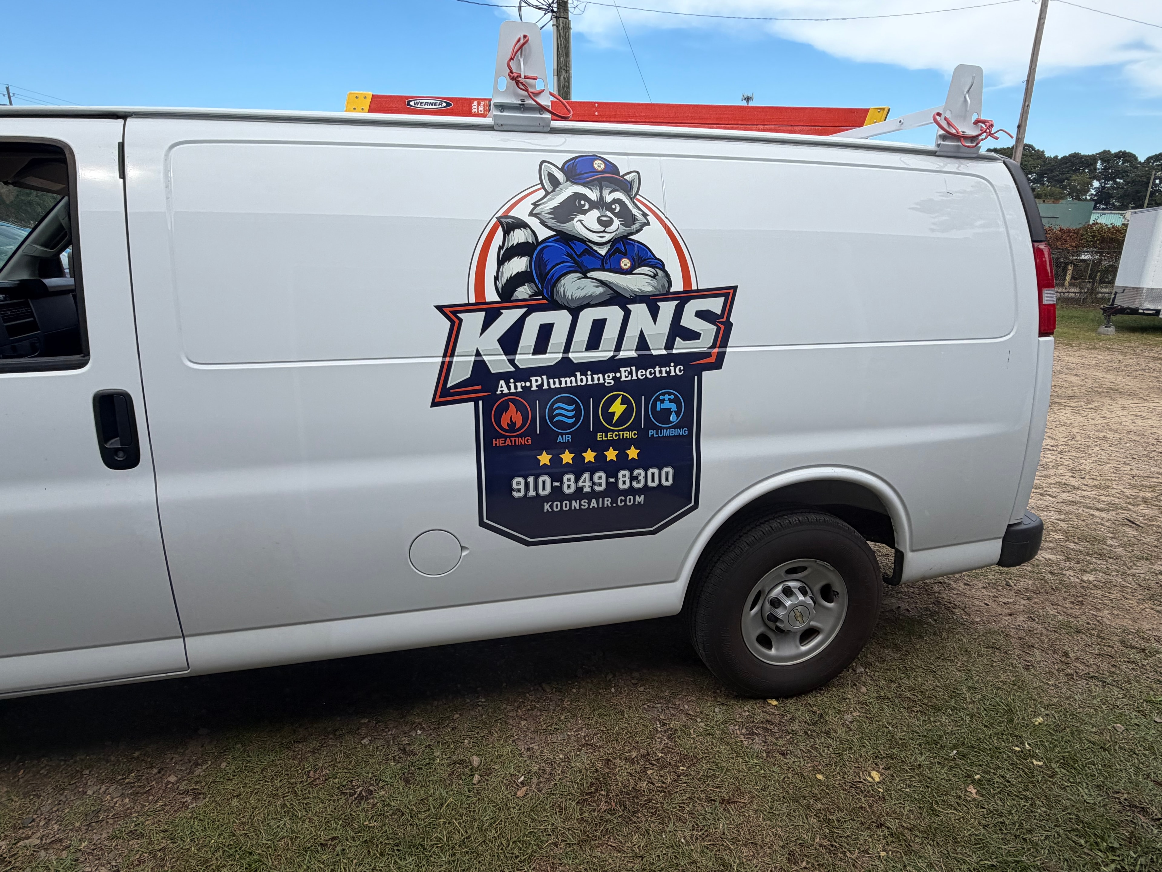 Koons Air Chevy van side with raccoon logo